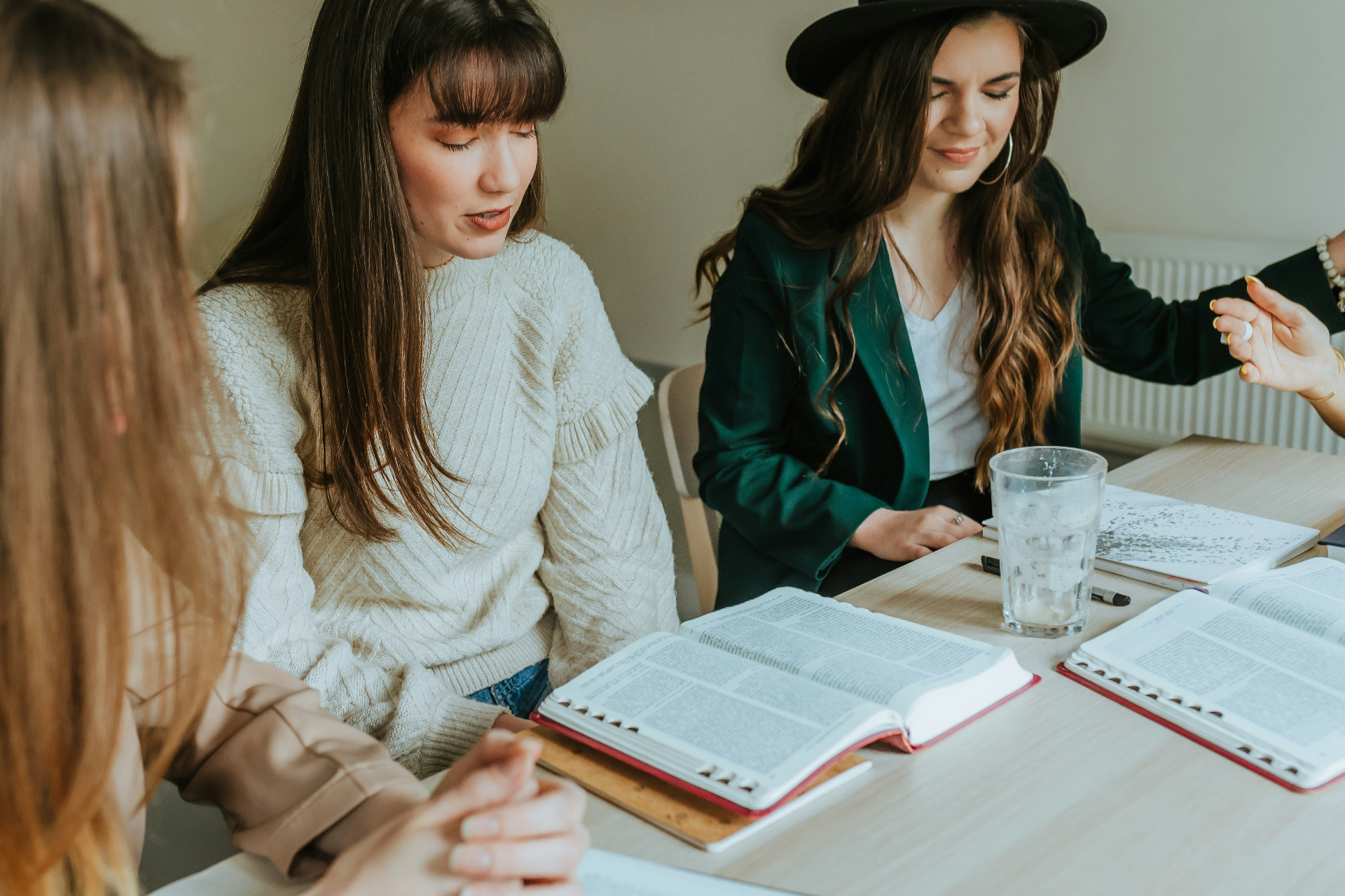 Women gathered around open Bibles in a small group study